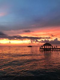 Scenic view of sea against orange sky