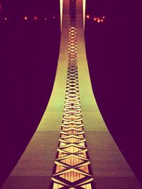 Illuminated tunnel at night