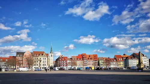 Buildings in city against blue sky