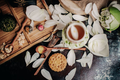 High angle view of coffee and petals on table