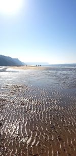 Scenic view of beach against clear blue sky