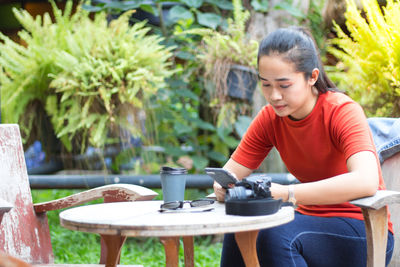 Young woman sitting on table