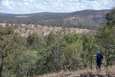 Rear view of man on landscape against mountains