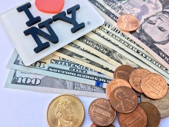 Close-up of text with money on table