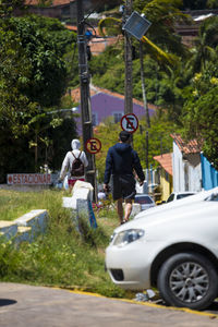 Rear view of people on street in city