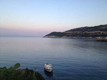 Boat moored at sea against sky