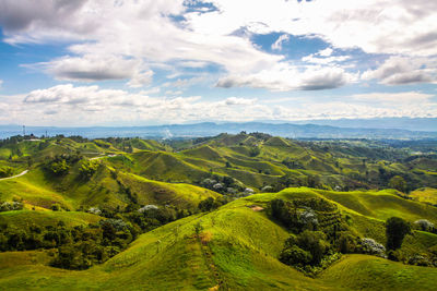 Scenic view of landscape wit mountains  against sky with clouds 