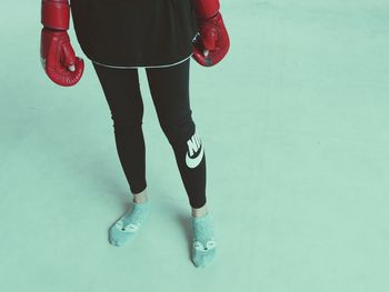 Low section of woman standing on red floor