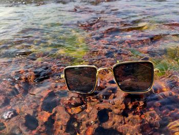 Close-up of sunglasses on beach