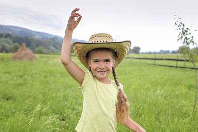 Portrait of smiling girl on grassy field