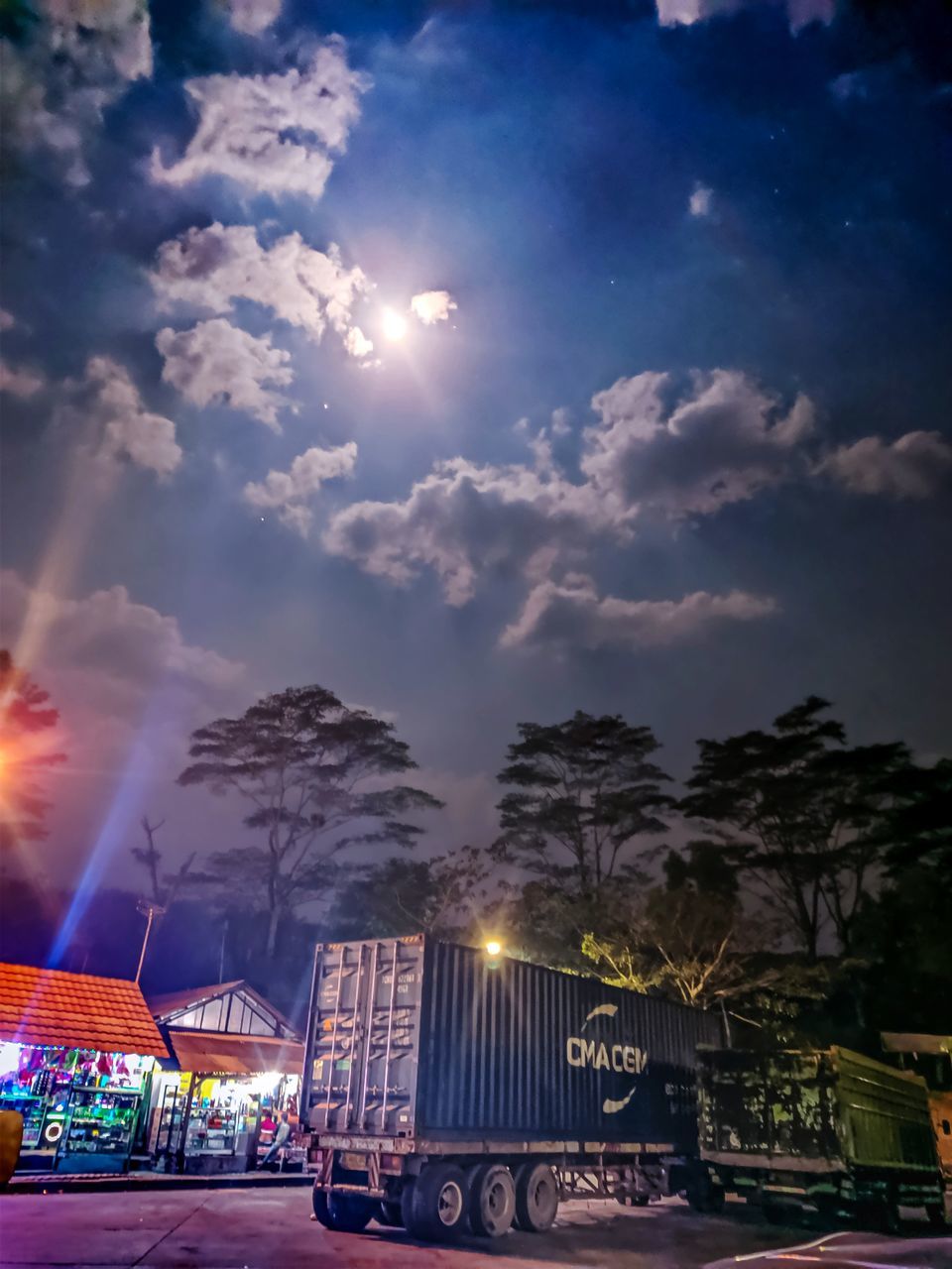 LOW ANGLE VIEW OF ILLUMINATED BUILDING AGAINST SKY