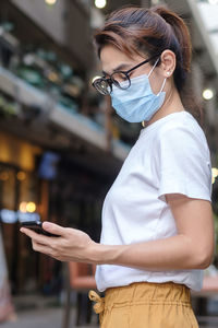 Midsection of woman using mobile phone
