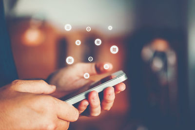 Midsection of man using mobile phone