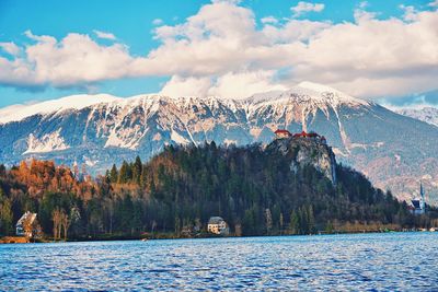 Scenic view of lake by mountains against sky
