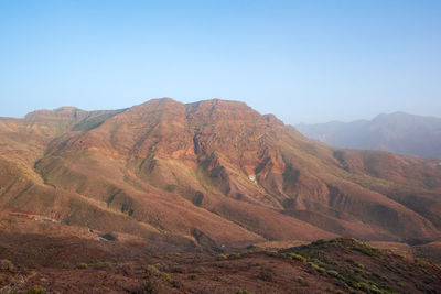 Scenic view of mountains against clear blue sky