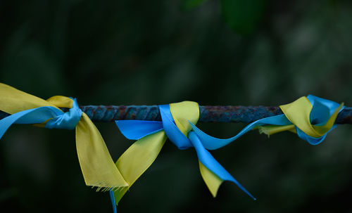 Blue and yellow silk ribbon tied on a metal tube. ukrainian flag symbol, struggle for independence