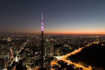 High angle view of city lit up at night