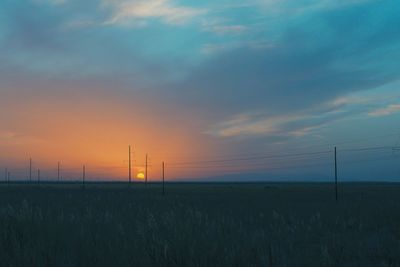 Scenic view of field against sky during sunset