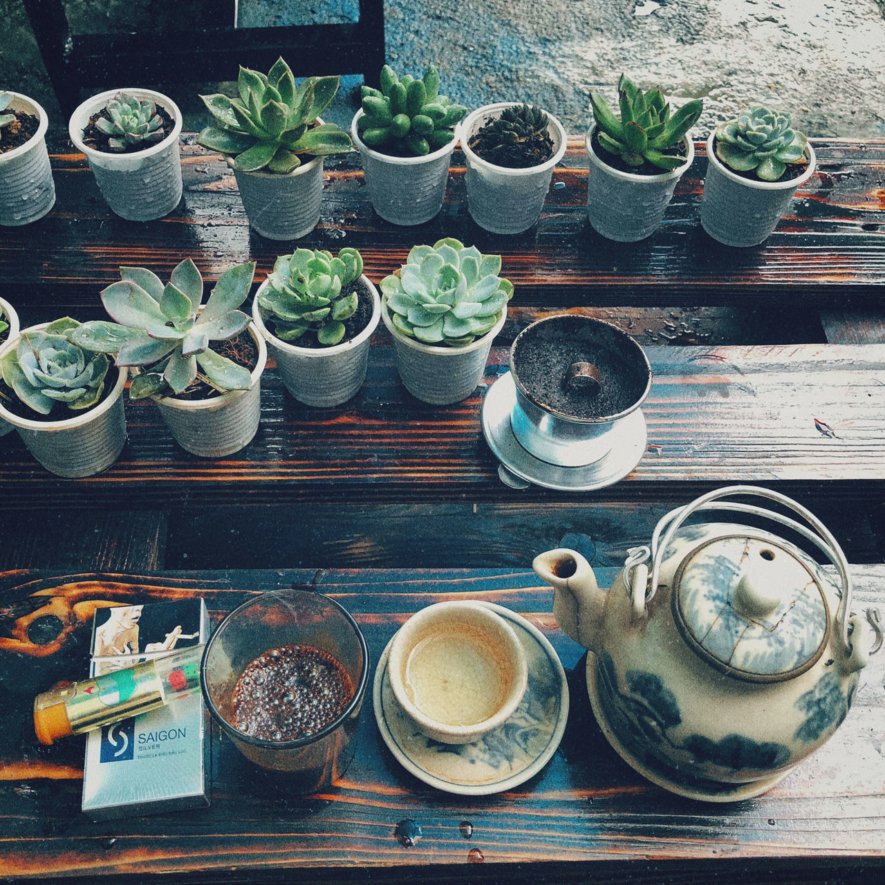 food and drink, high angle view, table, no people, food, potted plant, cup, container, wood, still life, drink, large group of objects, succulent plant, plant, blue, day, indoors, freshness, directly above, mug, variation, arrangement