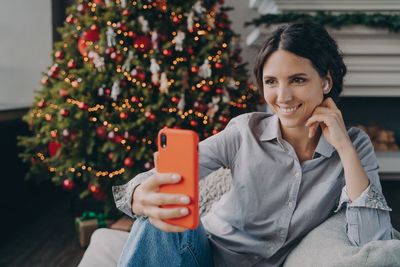 Smiling woman talking on video call at home