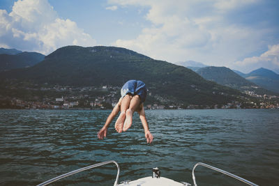 Rear view of man diving into lake