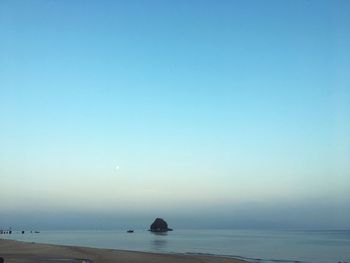 Scenic view of sea against clear sky during sunset