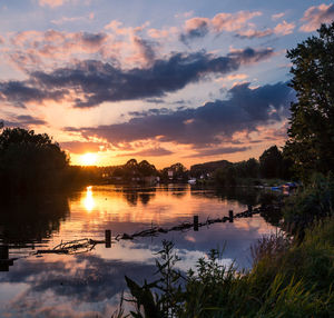 Scenic view of lake against orange sky