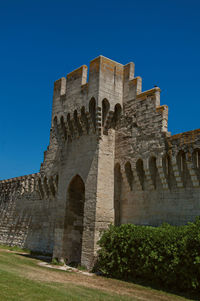 Low angle view of historical building against blue sky