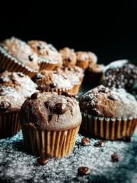 Close-up of muffins on table against black background