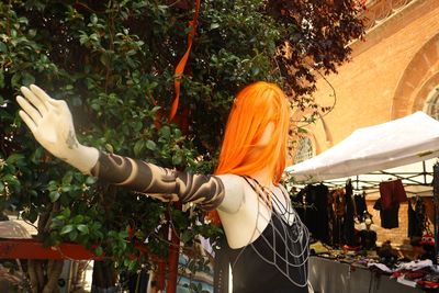 Rear view of woman standing by plants