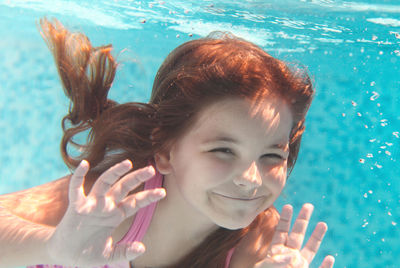 Portrait of woman swimming in pool