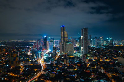 Illuminated cityscape against sky at night