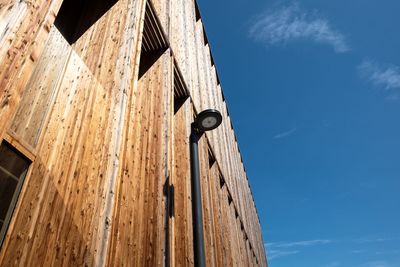 Low angle view of clock against blue sky