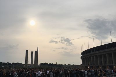 People at town square against sky during sunset