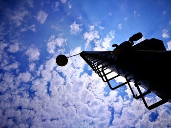 Low angle view of silhouette built structure against sky