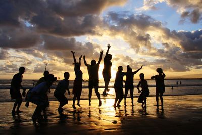 People on beach at sunset