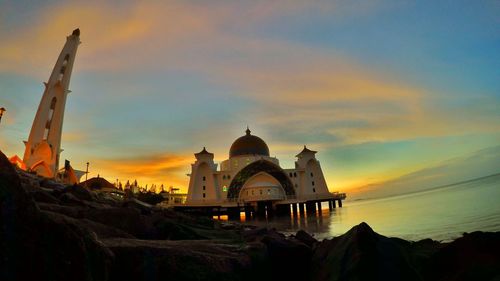 Built structure against sky at sunset