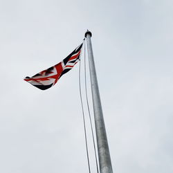 Low angle view of british flag against sky