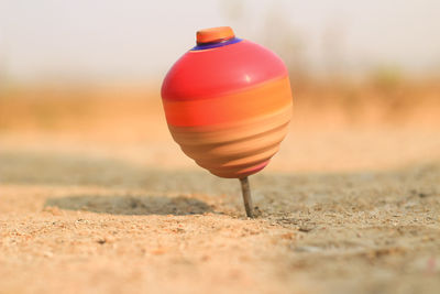 Close-up of orange toy on field