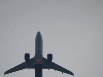 Low angle view of airplane against clear sky