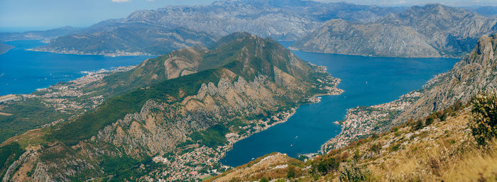 High angle view of sea and mountains against sky