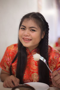 Close-up portrait of smiling woman having food