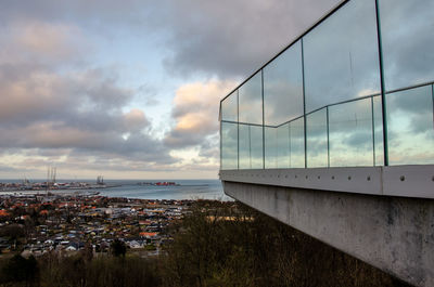 High angle view of buildings by sea against sky