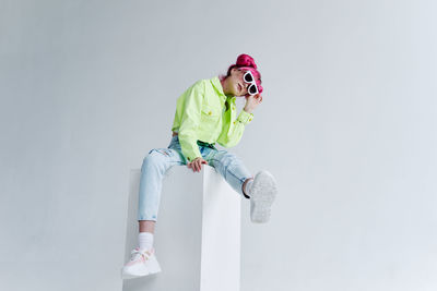 Portrait of young woman against white background