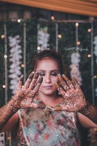 Portrait of woman with arms raised