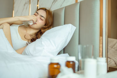 Portrait of woman relaxing on bed at home