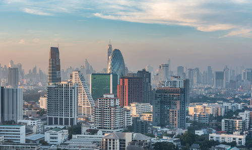 Aerial view of modern buildings in city against sky