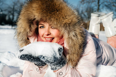 Portrait of smiling woman in snow