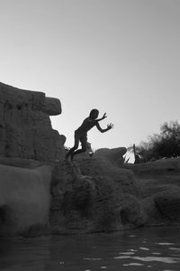 Full length of boy diving into pond