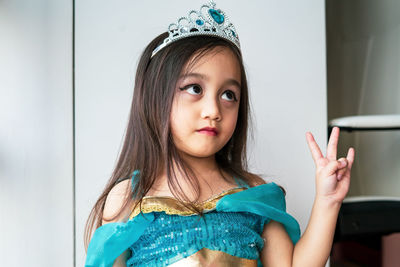 Portrait of cute girl dressing up as arabian princess looking up.